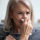sick older woman blowing nose
